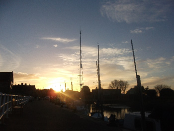 sun shining through boat masts